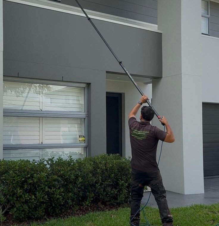 Technician using an extension pole for external window cleaning at a Sydney home