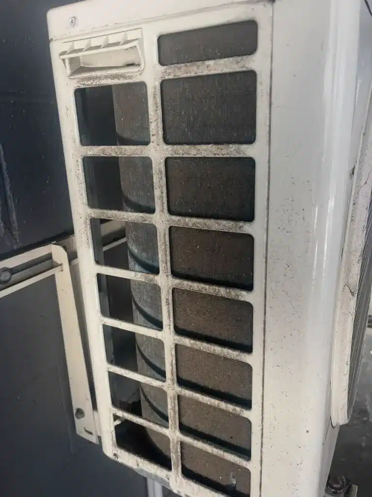 Ducted aircon outdoor unit being checked during a free home inspection